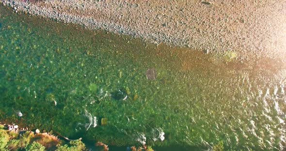 Low Altitude Flight Over Fresh Fast Mountain River with Rocks at Sunny Summer Morning.