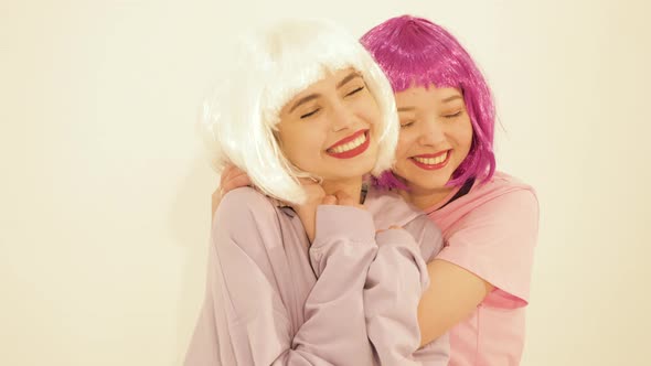 Two carefree young girls going crazy. Women dancing in hipster summer clothes