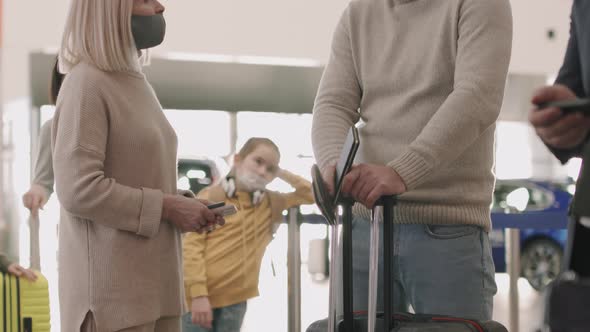 Talking Couple In Queue At Check-In