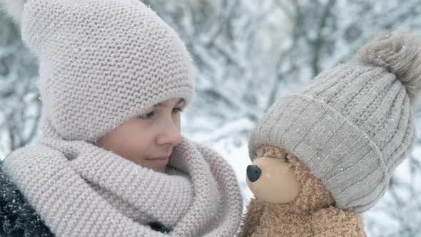 Play with teddy in winter.