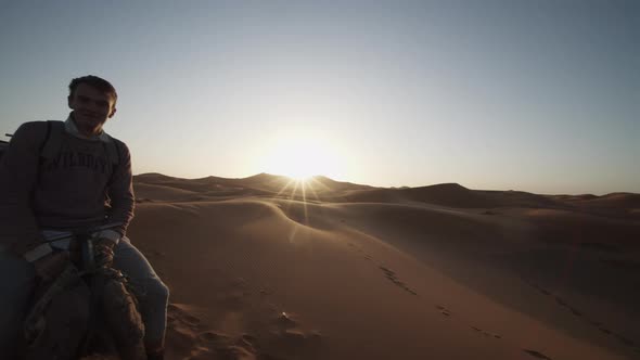 Backwards Tracking of Tourists Riding Camels in Caravan Through Sand Desert