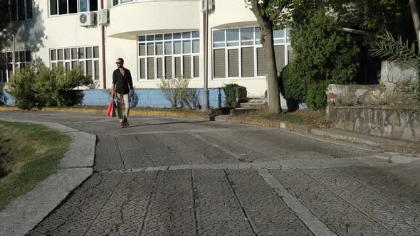 Young Man Walking With Bag