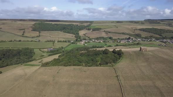 Forward tracking aerialing across the copse beside St Catherine's Chapel near the village of Abbotsb