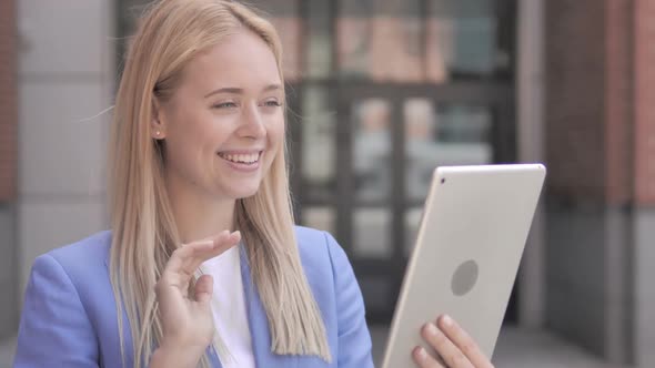 Outdoor Video Chat on Tablet By Young Businesswoman