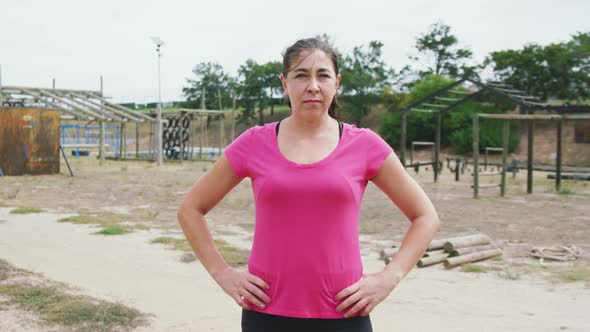 Caucasian woman looking at camera at boot camp