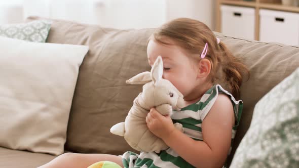 Baby Girl Playing with Toy Rabbit at Home