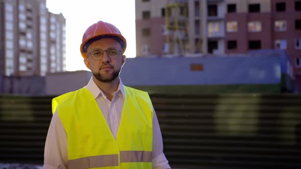 Worker Stands and Looks on the Camera