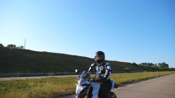 Man in Helmet Riding Fast on Sport Motorbike at Highway. Motorcyclist Racing His Motorcycle