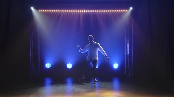 Contemporary Ballet, a Man Performs Elements of Modern Choreography and Jumps in the Spotlight