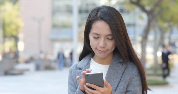 Business woman using smart phone at outdoor