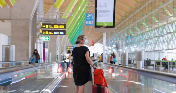 A passenger uses the flat escalator at Madrid airport
