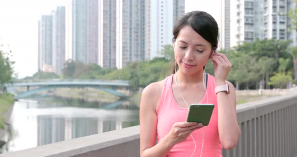 Sport woman listen to music on cellphone at outdoor