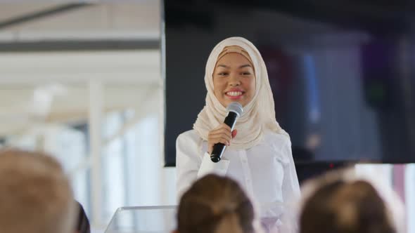 Female speaker addressing the audience at a business conference