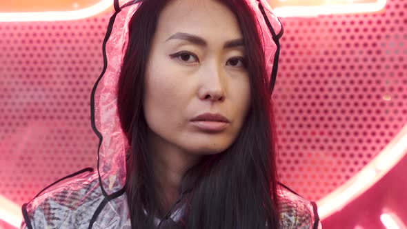 Headshot Portrait of Confident Mature Asian Woman in Neon Light