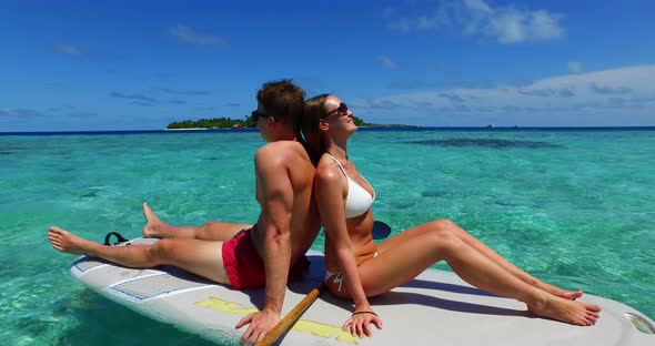 Young man and woman after marriage in love enjoy luxury on beach on sunny white sandy background 4K