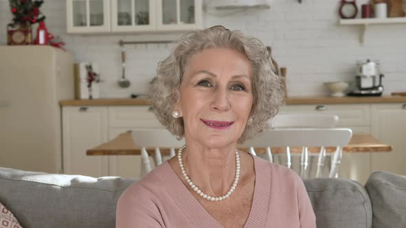 Nice Elderly Woman Wearing Pearl Necklace Smiles Gently