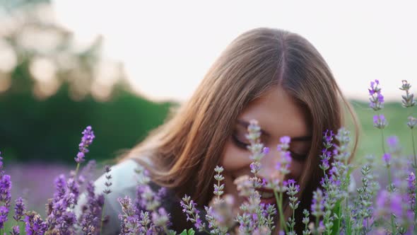 Smiling Woman Sitting in Lavender Field