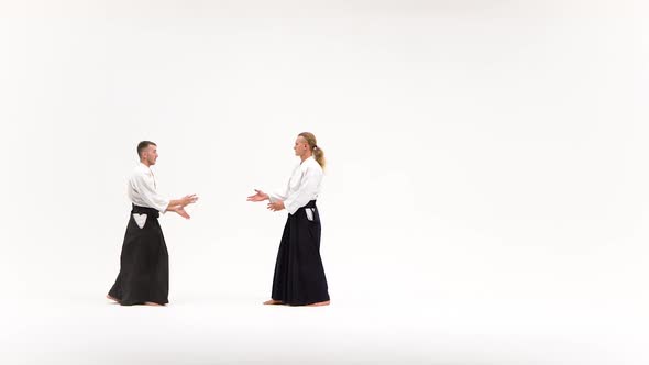 Two Males in Kimono Practicing Aikido Techniques, Isolated on White