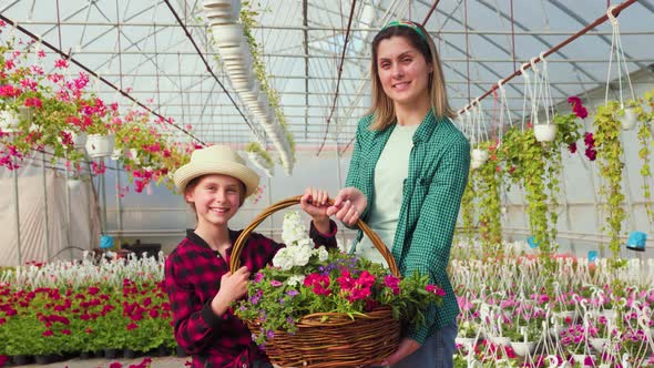 Her Mother and Daughter Hold a Beautiful Flower Basket in Their Hands