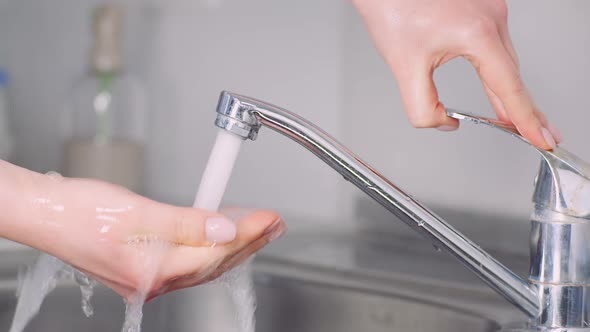 Man Washing Hands in Sink - Covid-19