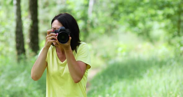 Female Photographer Take Photo with a Professional Camera Outdoor