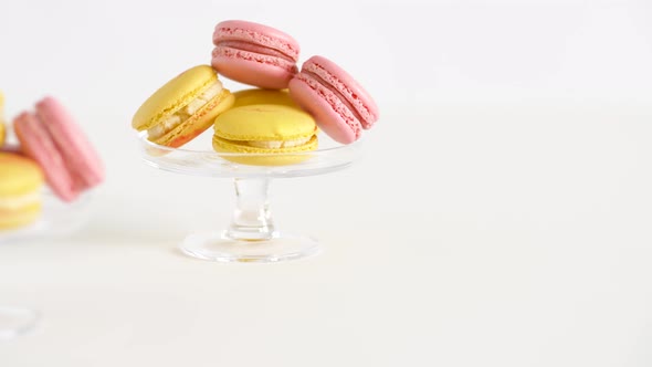 Yellow and Pink Macarons on Glass Stands