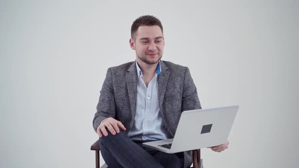 Portrait of a handsome businessman with a laptop