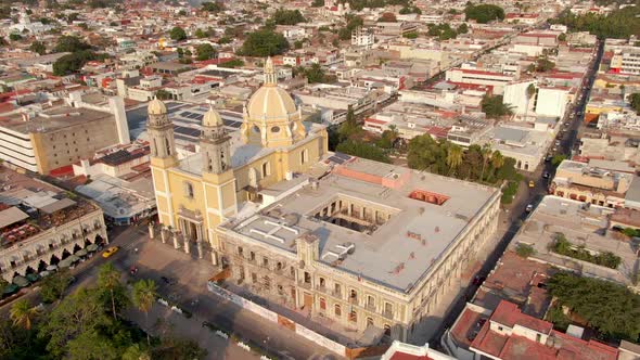 Bird's Eye View Of Cathedral Basilica of Colima With Government Palace In Colima City, Mexico. - aer