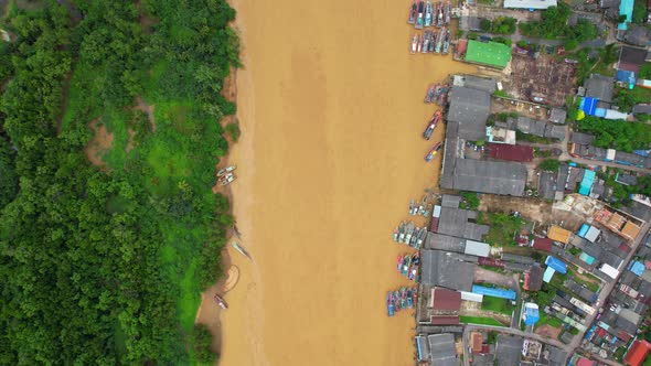 Aerial shot of river and local fisherman village beside the sea