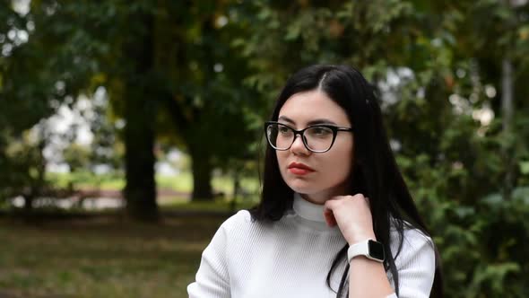 Sad Young Brunette Caucasian Girl in Glasses Portrait