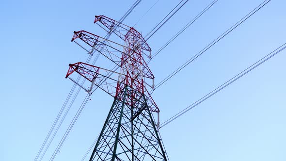 Electric Power Transmission Lines and Tower Against Blue Sky