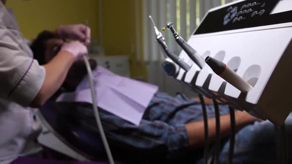 Hand of Dentist Taking Tool for Dental Cleaning