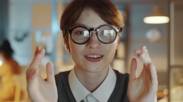 Young Businesswoman Speaking on Camera in Night Office