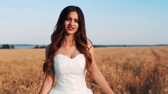 Bride In Wheat Field On Sunset