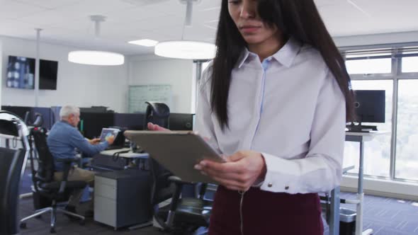 Woman using digital tablet at office