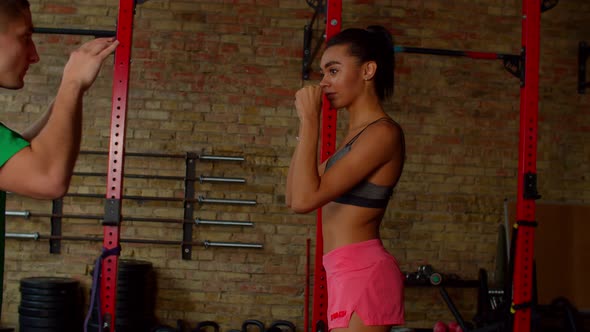 Portrait of Concentrated Athletic African Female Fighter Throwing One Two Combo