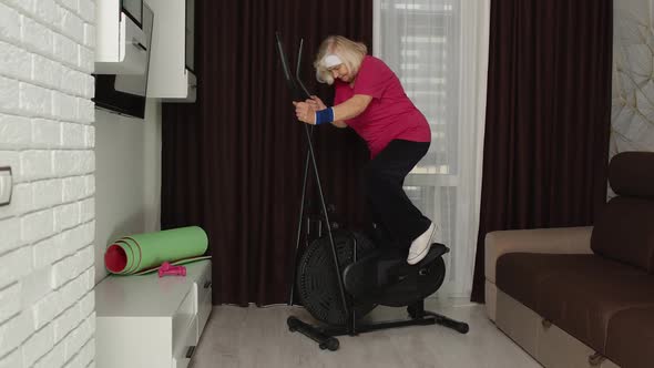 Senior Woman in Sportswear Using Orbitrek in Room at Home Doing Sport Training Cardio Exercises