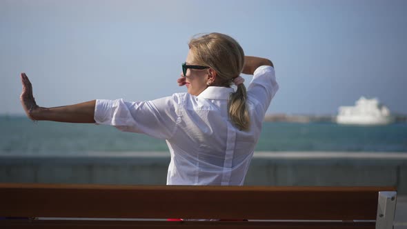 Back View of Cheerful Relaxed Caucasian Woman Stretching Smiling Admiring Beauty of Mediterranean