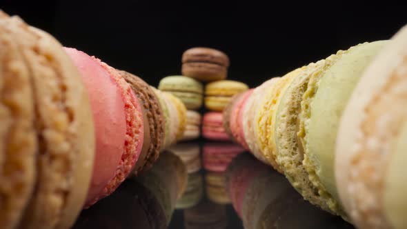 Colored Macaroons Confectionery Marshmallows on a Black Reflective Background in Perspective