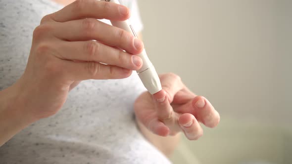 Pregnant Woman Holding Glucose Meter and Checking Sugar Level