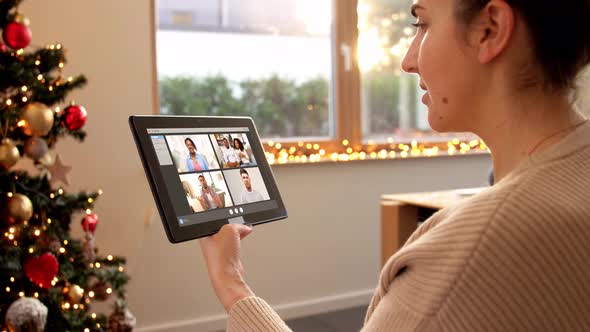 Woman with Tablet Pc Has Video Call on Christmas