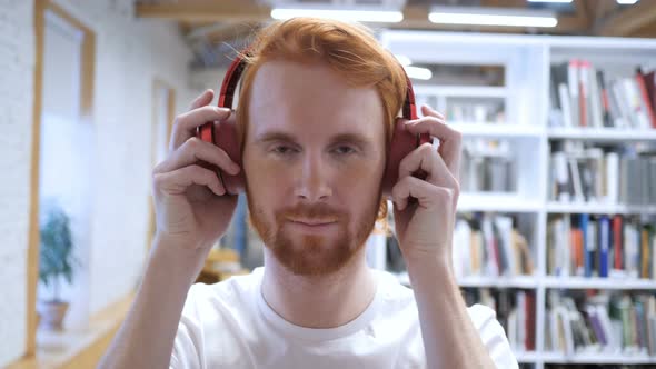 Young Man Wearing Headphones to Listen Music