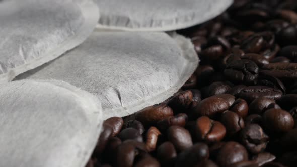 Filter coffee pods on roasted  beans 4K footage