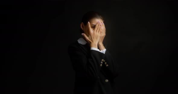 Funny Brunette Dressed in Business Clothes is Standing on Playing Hide and Seek