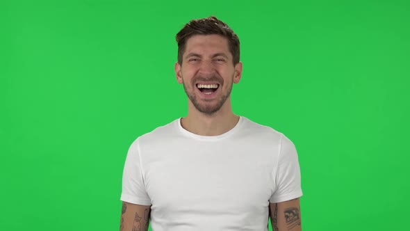 Portrait of Confident Guy Is Laughing. Green Screen