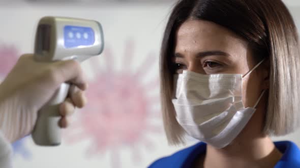 Taking woman 's temperature with thermometer to find infected by coronavirus, Covid-19