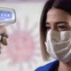 Taking woman 's temperature with thermometer to find infected by coronavirus, Covid-19 - VideoHive Item for Sale