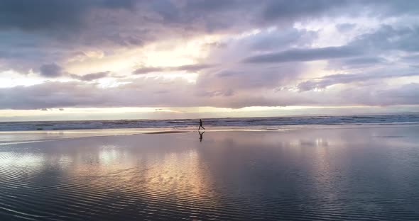 Girl Running on an Empty Beach