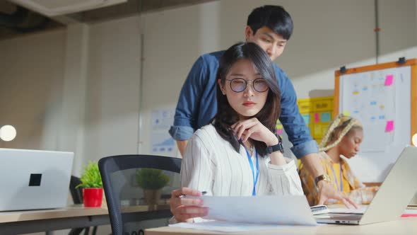 Asian staff creative senior designer coworkers consulting in office