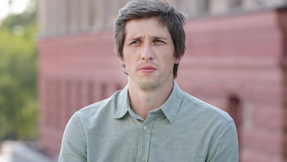 Headshot Closeup Portrait Unhappy Young Caucasian Guy Sniffing Air Closing Nose Holding Breath